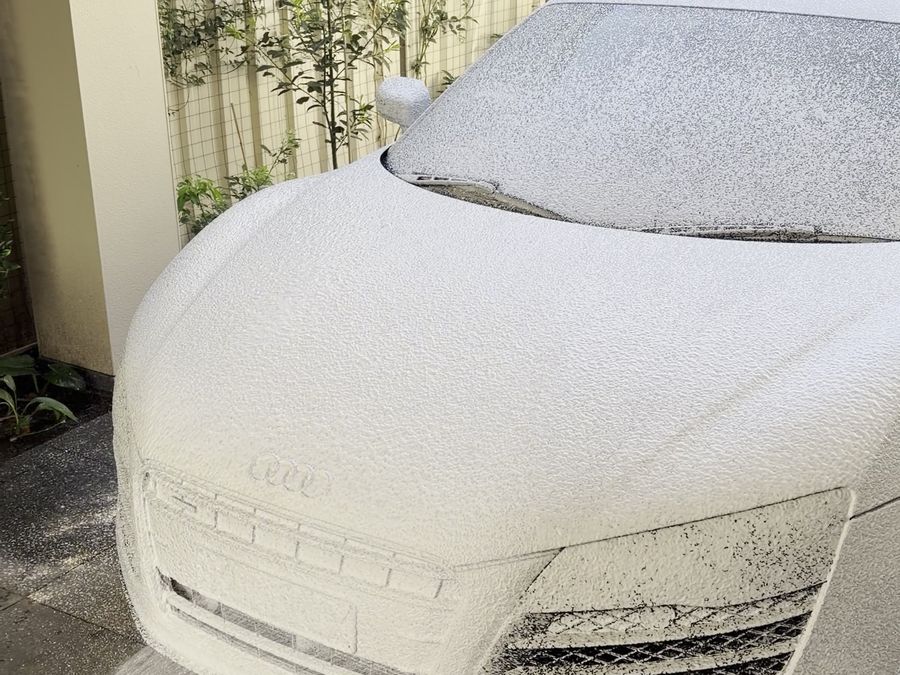 Audi R8 being covered in snow foam on the owner's driveway