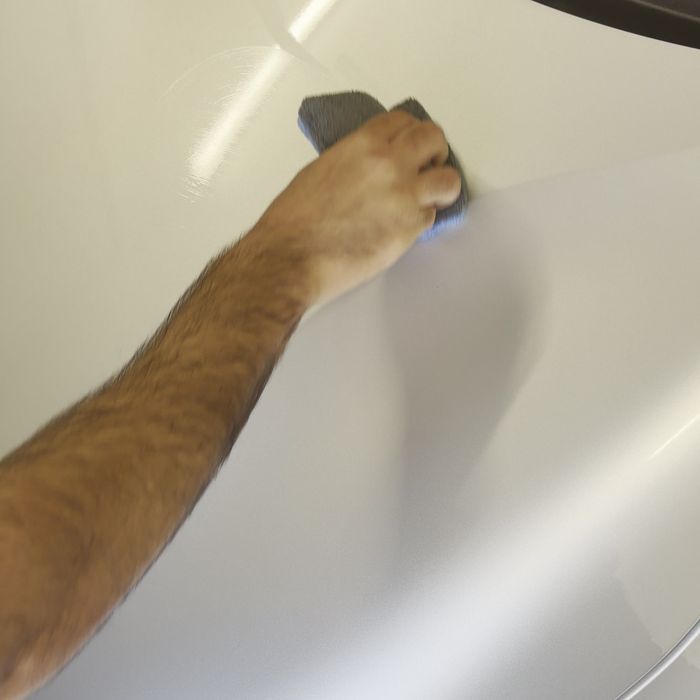 Ceramic coating being applied to a bonnet