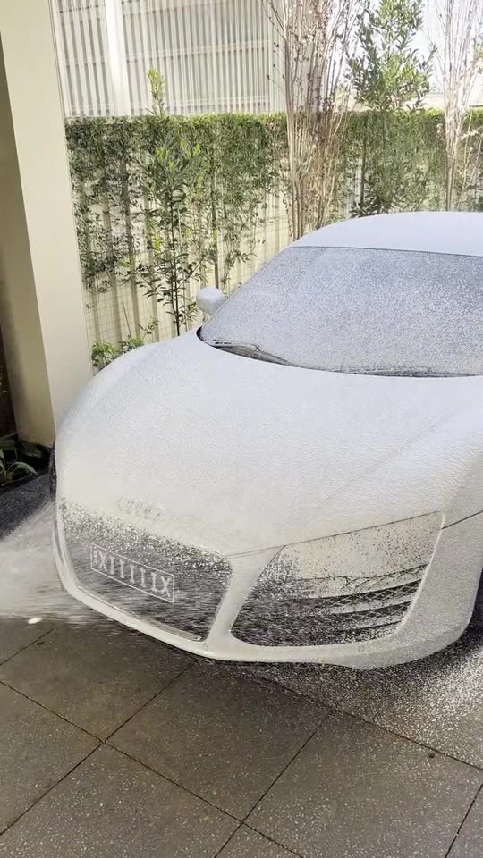 A white Audi R8 covered in snow foam during a Polo full detail