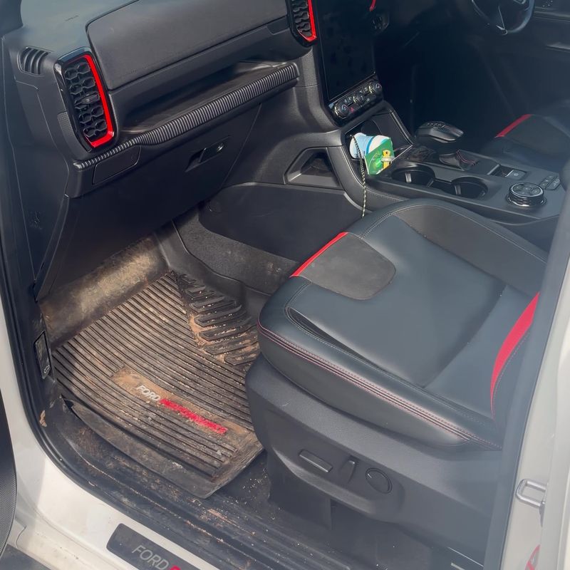 Ford Ranger Raptor front footwell full of red dirt before the detail