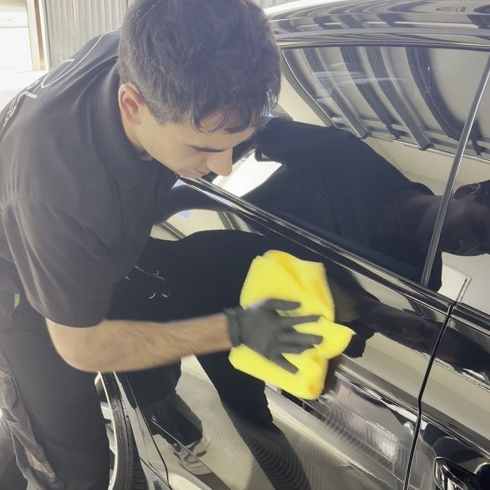 Wiping back a polished panel to check the finish